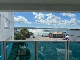 A view of the sea with a boat and construction site at Flat 17 Golden Gates Sandbanks