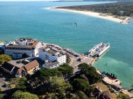 An aerial view of a ferry terminal with buildings and parking at Flat 17 Golden Gates Sandbanks