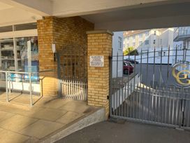 An outdoor entrance with a gate and sign at Flat 17 Golden Gates in Sandbanks