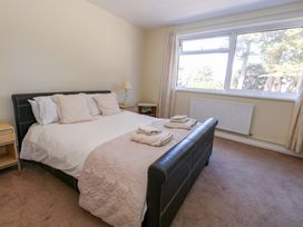 A bedroom with a bed and nightstand at Flat 17 Golden Gates Sandbanks