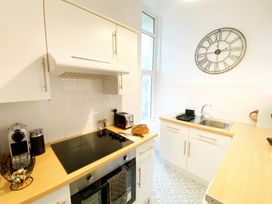 A kitchen with cabinets and a sink at 2A Redcliffe in Torquay