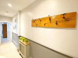A hallway with wall hooks and a wooden panel at 2A Redcliffe, Torquay