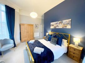 A bedroom with a bed and wardrobe at 2A Redcliffe in Torquay