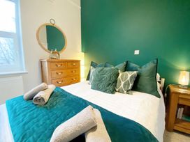 A bedroom with a bed and a chest of drawers at 2A Redcliffe in Torquay