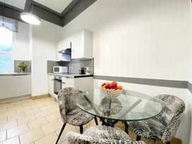 A kitchen with a table and chairs at 2B Redcliffe in Torquay