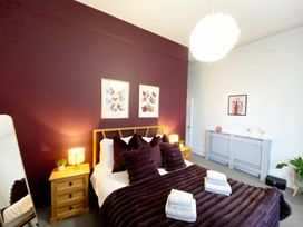 A bedroom with a bed and decorative items at 2B Redcliffe in Torquay