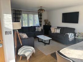 A living room with a sofa and television at Seaview in Pakefield