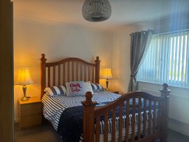 A bedroom with a bed and bedside table at Seaview in Pakefield
