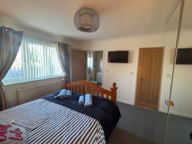 A bedroom with a bed and towels at Seaview in Pakefield