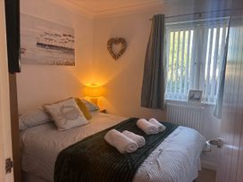A bedroom with a bed and lamp at Seaview in Pakefield