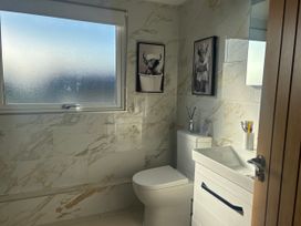 A bathroom with toilet and sink at Seaview in Pakefield