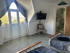 A bedroom with a bed and tv at Seaview in Pakefield