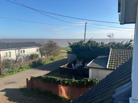 A view of the sea and houses from an outdoor area at Seaview in Pakefield