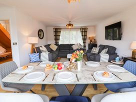 A dining room with a table set for meals at Seaview in Pakefield