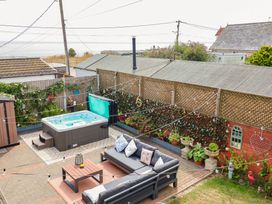 A garden with a hot tub and sitting area at Seaview in Pakefield