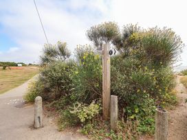 A footpath sign near bushes and a path at Seaview in Pakefield