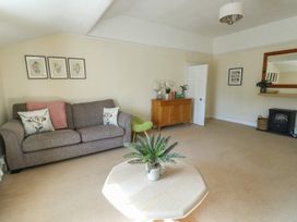 A living room with a sofa and coffee table at Castle Gardens Apartment Beaumaris