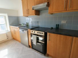 A kitchen with cabinets and appliances at Castle Gardens Apartment Beaumaris