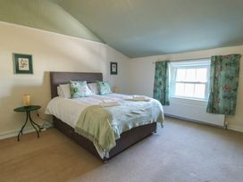 A bedroom with a bed and bedside table at Castle Gardens Apartment Beaumaris