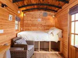 A bedroom with a bed and sofa at The Damselfly in 