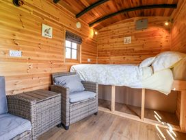 A bedroom with a bed and seating area at The Damselfly in 