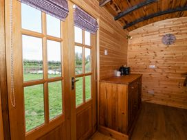 A wooden interior with a table and coffee maker at The Damselfly