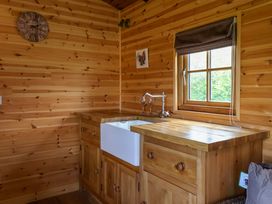 A kitchen with a sink and wooden units at The Damselfly in 