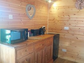 A kitchen with a microwave, kettle, and coffee maker at The Damselfly Bewholme near Hornsea