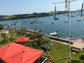 A marina with boats and umbrellas at 24 The Salcombe in Salcombe