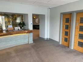 A lobby with a reception desk and bathroom doors at 24 The Salcombe in Salcombe