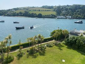 A view of boats on water with grass and plants at 24 The Salcombe Salcombe