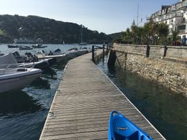 A dock with boats alongside water at 24 The Salcombe in Salcombe