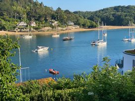 A view of boats in water with beach and houses at 24 The Salcombe Salcombe