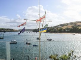 A view of flags and boats on water at 24 The Salcombe in Salcombe