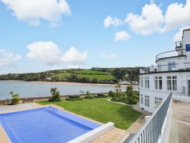 An outdoor space with a swimming pool and lawn at 24 The Salcombe in Salcombe