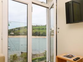 A living room with a view of the water at 24 The Salcombe in Salcombe