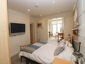 A bedroom with a bed and television at 24 The Salcombe in Salcombe