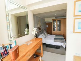 A bedroom with a bed and furniture at 24 The Salcombe in Salcombe