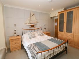 A bedroom with a bed and wardrobe at 24 The Salcombe in Salcombe