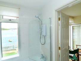 A bathroom with a shower and window at 24 The Salcombe in Salcombe