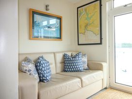 A snug area with a sofa and cushions at 24 The Salcombe in Salcombe