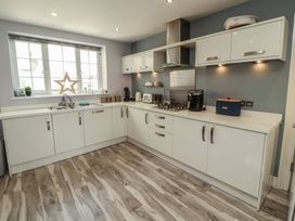 A kitchen with cabinets and appliances at Sugar Loft in Silloth