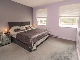 A bedroom with a bed and bedside table at Sugar Loft in Silloth