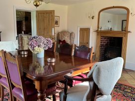 A dining room with a table and chairs at Cutbush Farmhouse in Norwich