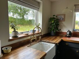 A kitchen with a sink and window at Cutbush Farmhouse in Norwich