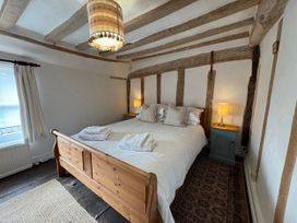 A bedroom with a bed and bedside tables at Cutbush Farmhouse in Norwich