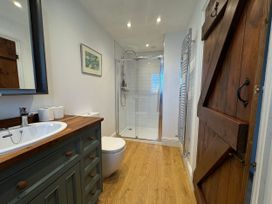 A bathroom with a shower and sink at Cutbush Farmhouse in Norwich