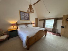 A bedroom with a bed and bedside tables at Cutbush Farmhouse in Norwich