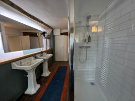 A bathroom with two sinks and a shower at Cutbush Farmhouse in Norwich