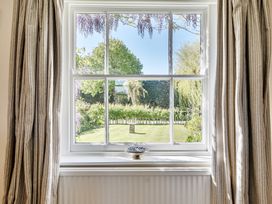 A window with a view of a garden at Cutbush Farmhouse in Hingham
